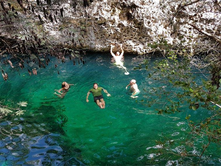 Tourists swim in a cenote in the Bay of Pigs, Cuba Tourists swim in a cenote in the Bay of Pigs, Cuba
