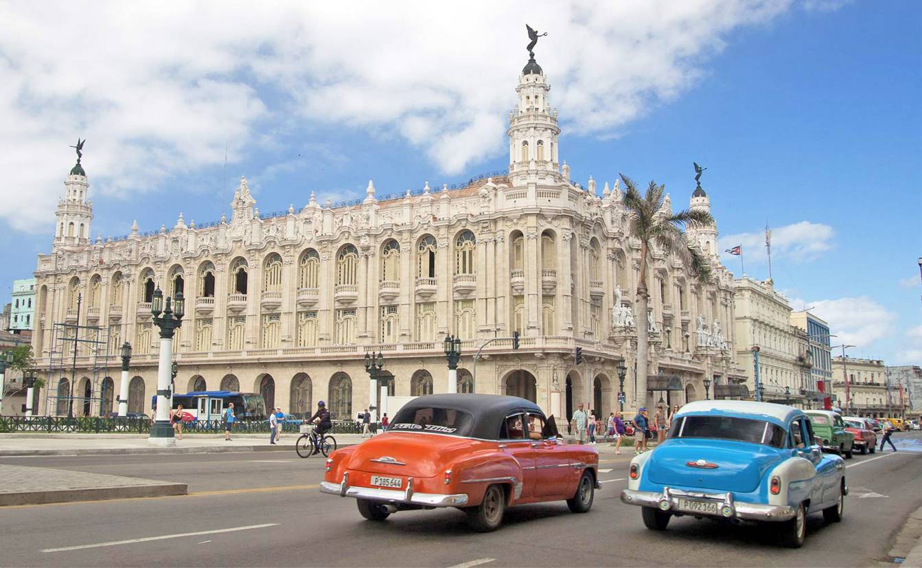 Two classic American 50’s cars in front of the Gran Teatro in Havana