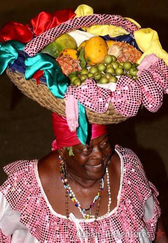 Woman with fruit basket on her head in Santiago de Cuba's Carnival Woman with fruit basket on her head in Santiago de Cuba's Carnival